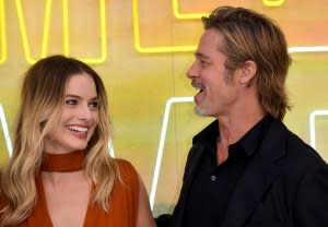 Margot Robbie Reveals She Improvised a 'Babylon' Scene to Kiss Brad Pitt: ‘Sue Me’ burnt orange dress