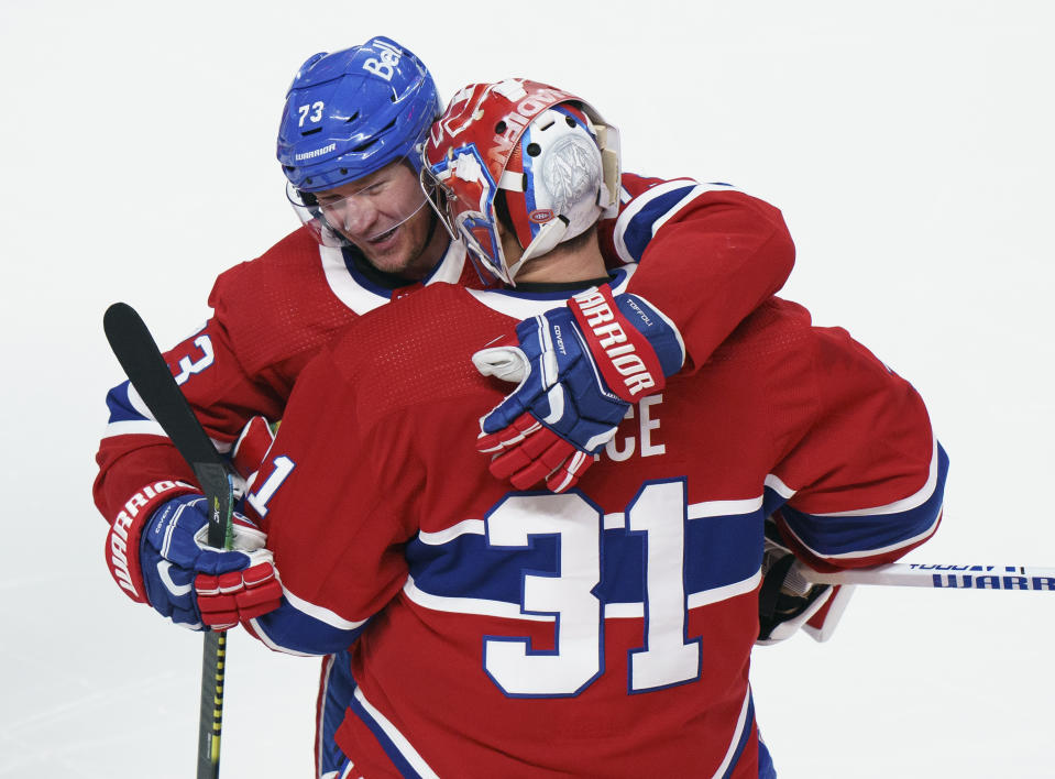 Montreal Canadiens' Tyler Toffoli (73) celebrates his winning goal with teammate Carey Price following overtime NHL Stanley Cup playoff hockey action against the Winnipeg Jets in Montreal, Monday, June 7, 2021. (Paul Chiasson/The Canadian Press via AP)