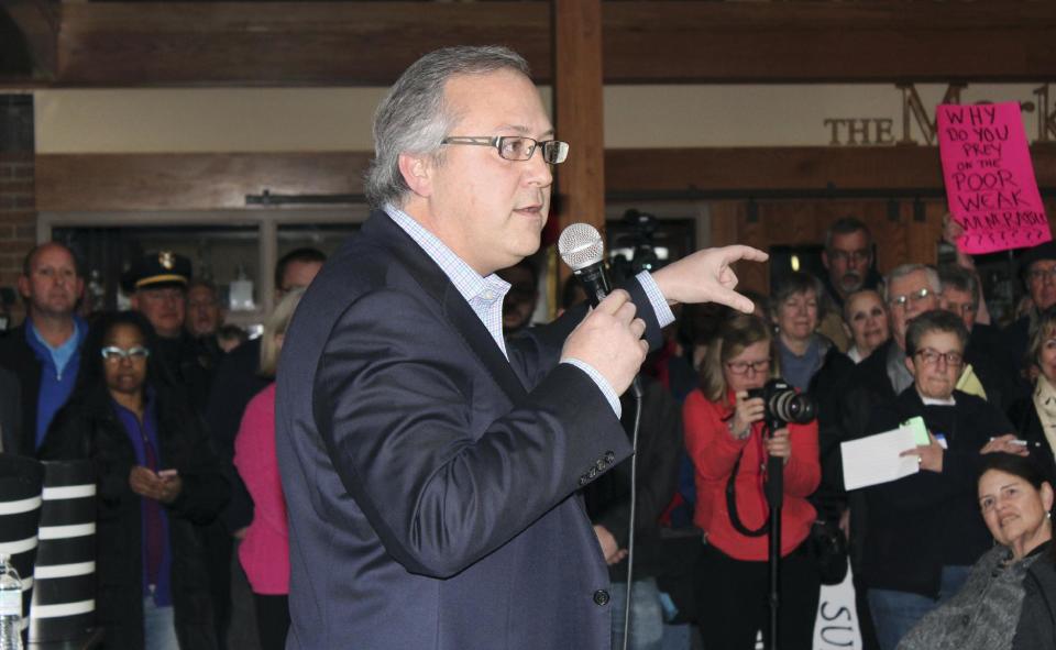 In this Thursday, Feb. 23, 2017, photo, Rep. David Young, R-Iowa, speaks to a crowd of about 400 people during a town hall meeting in Urbandale, Iowa. A week of protests and raucous town halls isn't deterring President Donald Trump or the Republican congressional leadership. They're "staying the course" on health care, taxes and other issues. But the national pushback leaves some Republicans wary, not only about the next steps on the agenda but the possibility it could prove costly in next year's elections. (AP Photo/Linley Sanders)