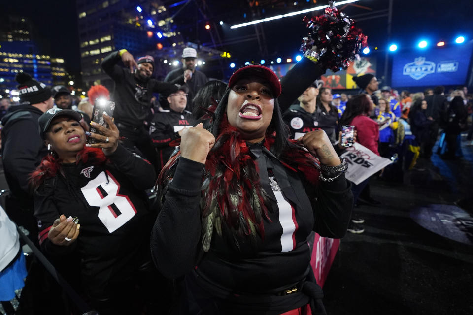 Atlanta Falcons fans cheer during the first round of the NFL football draft, Thursday, April 25, 2024, in Detroit. (AP Photo/Paul Sancya)