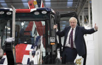 Britain's Prime Minister Boris Johnson signals to the media during an election campaign visit to the JCB manufacturing facility in Uttoxeter, England, Tuesday Dec. 10, 2019. The Conservative Party are campaigning for their Brexit split with Europe ahead of the UK's General Election on Dec. 12.(Stefan Rousseau/PA via AP)