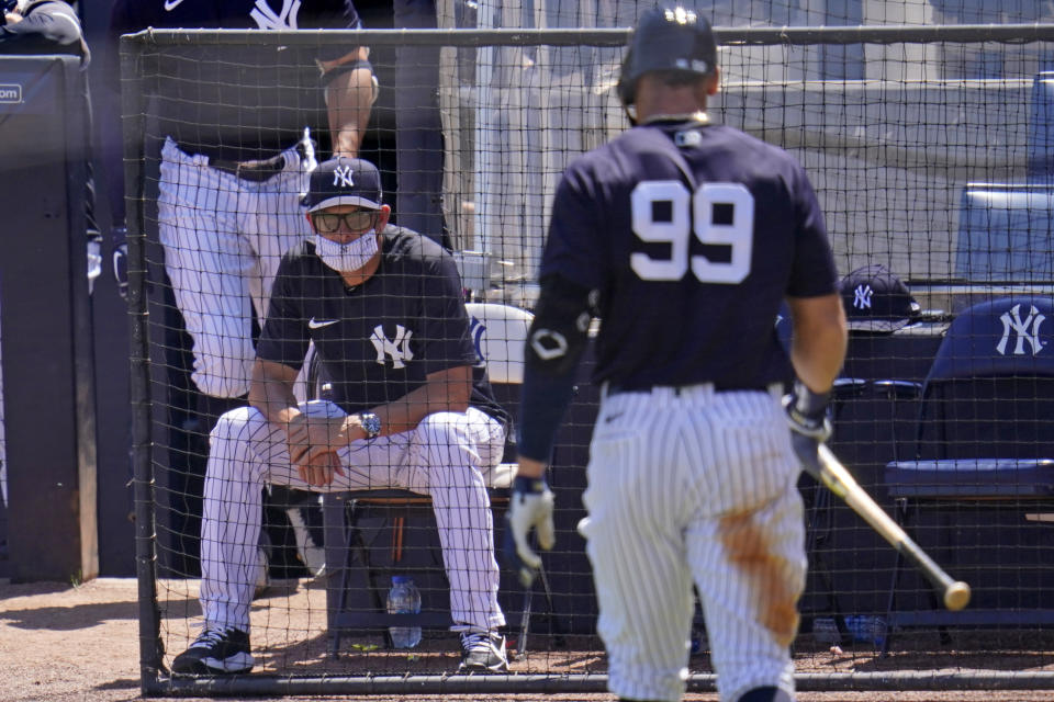 New York Yankees manager Aaron Boone watches as Aaron Judge (99) walks back to the dugout after striking out against Toronto Blue Jays starting pitcher Trent Thornton during the third inning of a spring training exhibition baseball game in Tampa, Fla., Wednesday, March 24, 2021. (AP Photo/Gene J. Puskar)