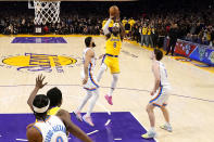 Los Angeles Lakers forward LeBron James (6) scores to pass Kareem Abdul-Jabbar to become the NBA's all-time leading scorer as Oklahoma City Thunder guard Josh Giddey (3) and forward Kenrich Williams defend during the second half of an NBA basketball game Tuesday, Feb. 7, 2023, in Los Angeles.(AP Photo/Ashley Landis)