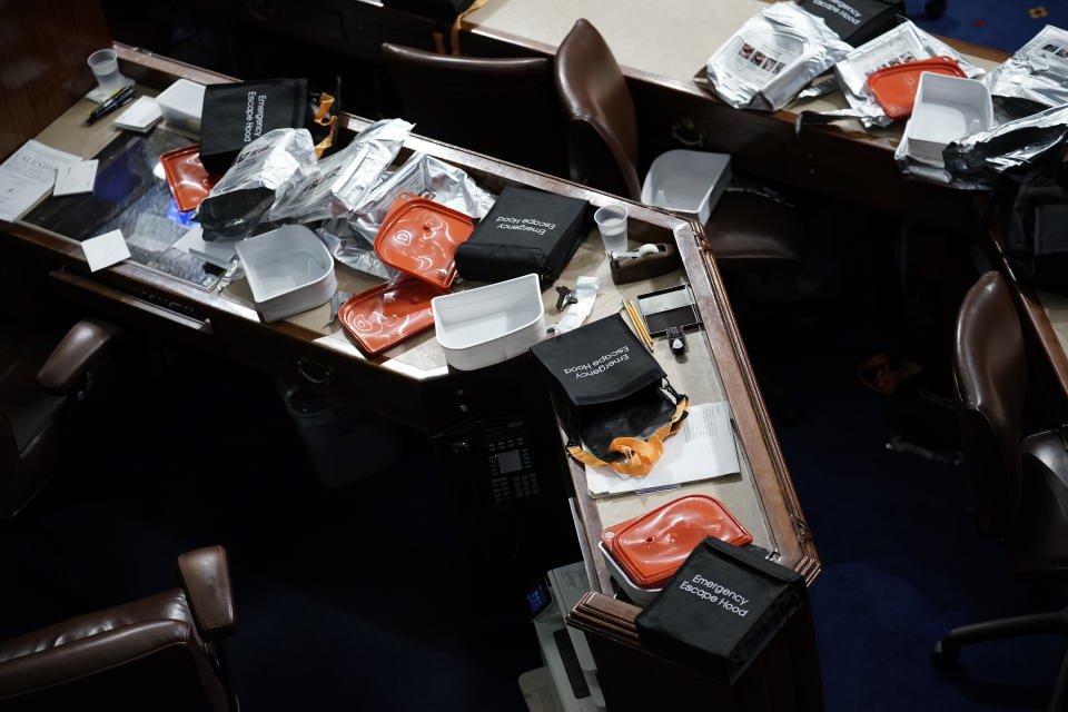 Papers and other equipment after the House floor was evacuate as rioters tried to break into the House Chamber at the U.S. Capitol on Wednesday, Jan. 6, 2021, in Washington. (AP Photo/J. Scott Applewhite)