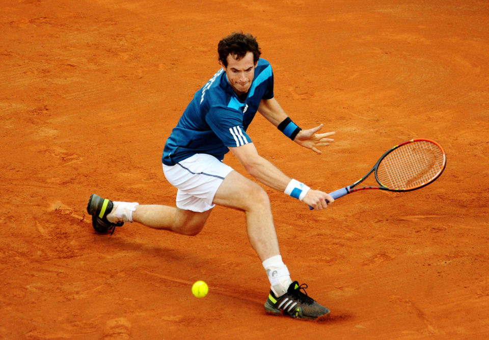 Britain's Andy Murray returns the ball to Italy's Andreas Seppi during their Davis Cup World Group quarterfinal match in Naples, Italy, Friday, April 4, 2014. (AP Photo/Salvatore Laporta)