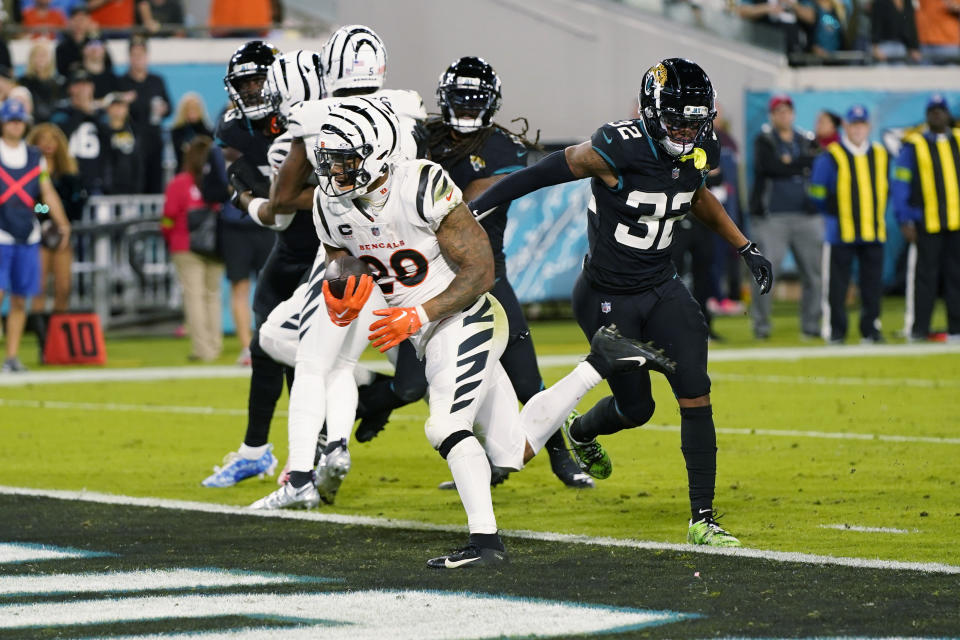 Cincinnati Bengals running back Joe Mixon (28) scores a touchdown during the first half of an NFL football game against the Jacksonville Jaguars, Monday, Dec. 4, 2023, in Jacksonville, Fla. (AP Photo/John Raoux)