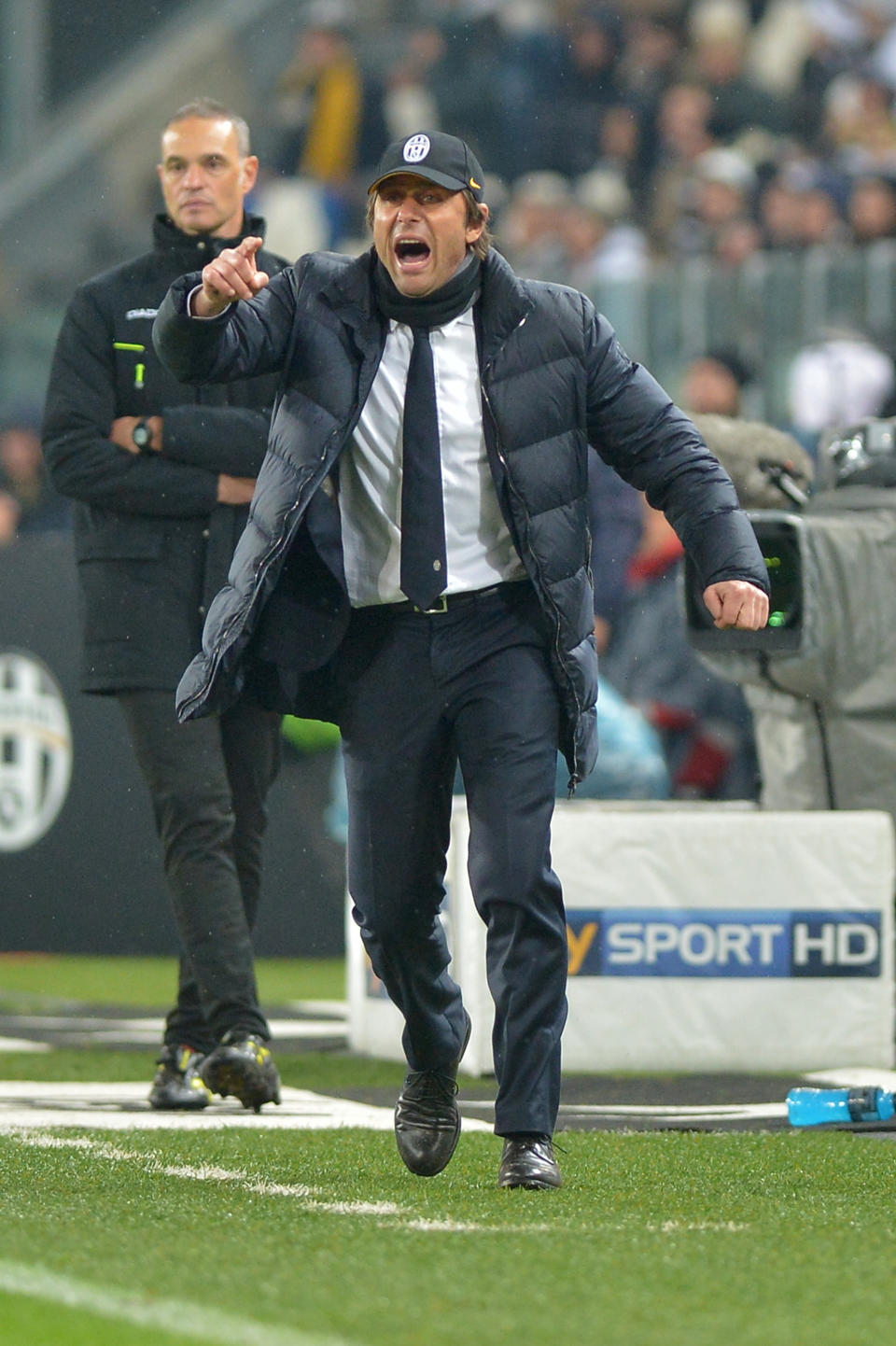 Juventus coach Antonio Conte gestures during a Serie A soccer match between Juventus and Parma at the Juventus stadium, in Turin, Italy, Wednesday, March 26, 2014. (AP Photo/Massimo Pinca)