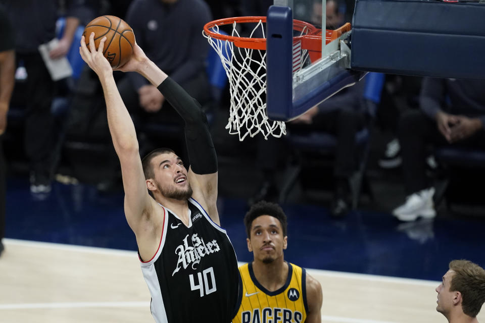 Los Angeles Clippers' Ivica Zubac (40) goes up for a dunk against Indiana Pacers' Malcolm Brogdon (7) during the first half of an NBA basketball game, Tuesday, April 13, 2021, in Indianapolis. (AP Photo/Darron Cummings)