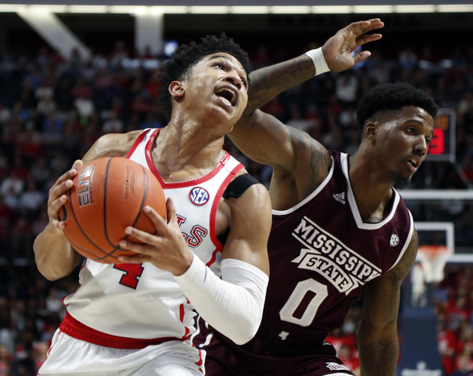 Mississippi guard Breein Tyree (4) pushes past Mississippi State guard Nick Weatherspoon (0) on his way to a layup during the first half of an NCAA college basketball game in Oxford, Miss., Saturday, Feb. 2, 2019. (AP Photo/Rogelio V. Solis)