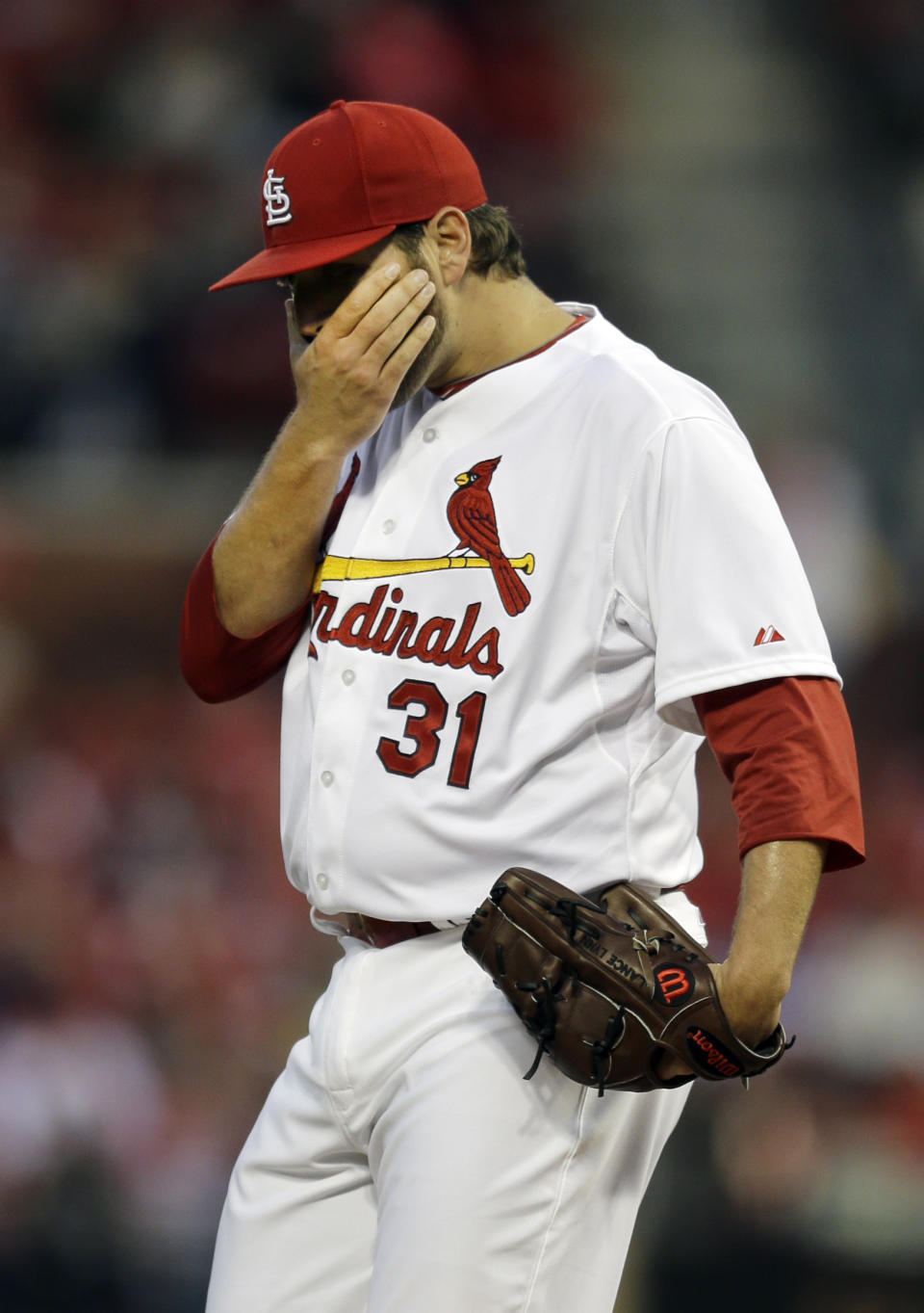 St. Louis Cardinals starting pitcher Lance Lynn pauses after giving up a double to Cincinnati Reds' Brandon Phillips during the first inning of a baseball game Tuesday, April 8, 2014, in St. Louis. (AP Photo/Jeff Roberson)