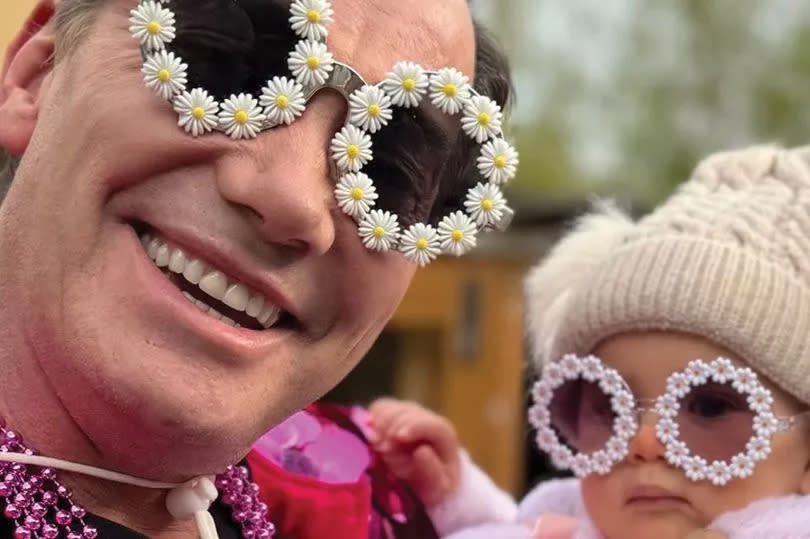 Craig Revel Horwood poses with the daughter of Strictly's Janette Manrara at festival themed birthday party