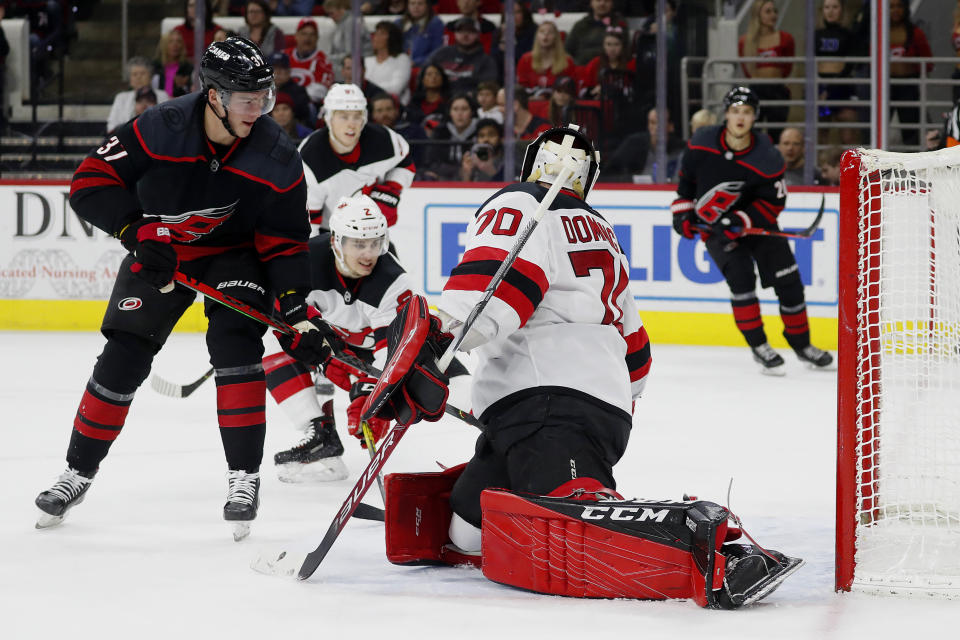 Carolina Hurricanes' Andrei Svechnikov (37), of Russia, deflects the puck past New Jersey Devils goaltender Louis Domingue (70) during the second period of an NHL hockey game in Raleigh, N.C., Friday, Feb. 14, 2020. (AP Photo/Karl B DeBlaker)