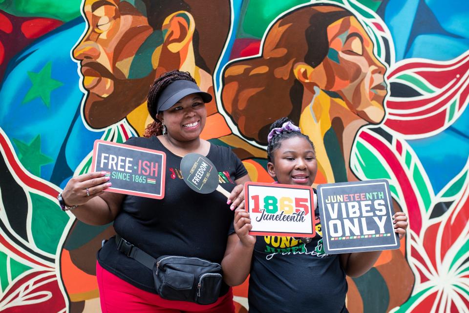 Renita Holmes and her daughter Elise Holmes, 9, both of Detroit, pose for a photo at the Photo Booth during Freedom Day Celebration at the Capitol Park in Detroit on Wednesday, June 19, 2024.