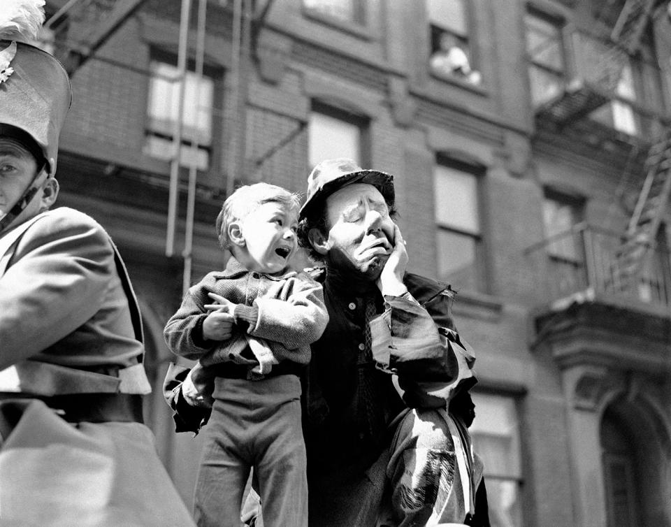 <p>Three-year-old Richard Caglione sheds tears as a stranger, in this case, Emmett Kelly, featured clown with Ringling Brothers and Barnum and Bailey Circus, picks him up during New York’s first circus parade in 19 years on April 9, 1945, which launched the first phase of the Seventh War Loan Drive. (AP Photo/Anthony Camerano) </p>