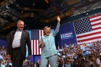 Democratic presidential candidate Hillary Clinton and vice presidential candidate Tim Kaine greet supporters during a campaign rally on July 23, 2016 in Miami, Florida