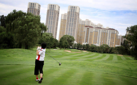 A golfer tees off at Huatang International Golf Club in Beijing - Credit: National Geographic Creative / Alamy Stock Photo