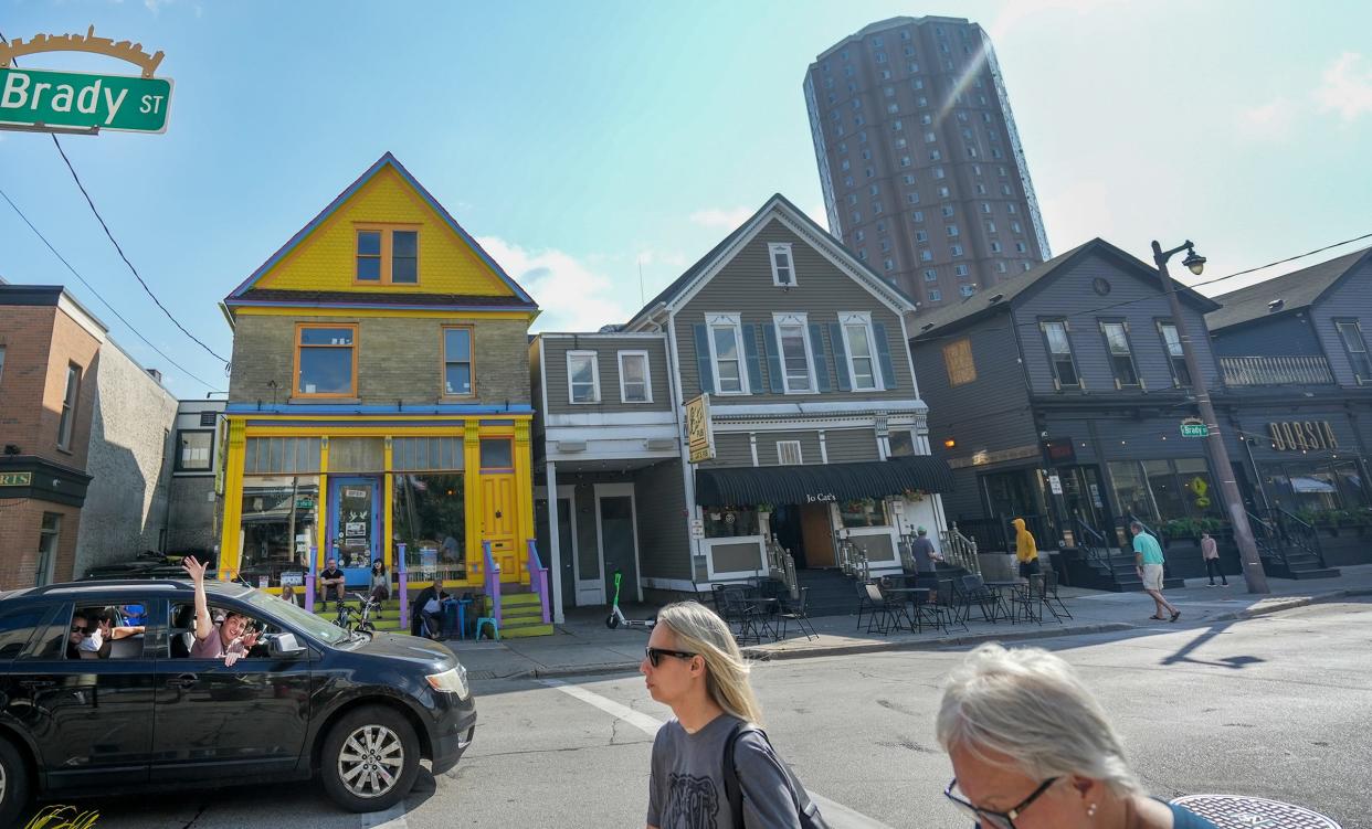 Pedestrians and passengers travel past Brady Street's restaurants, shops and bars in September 2022.