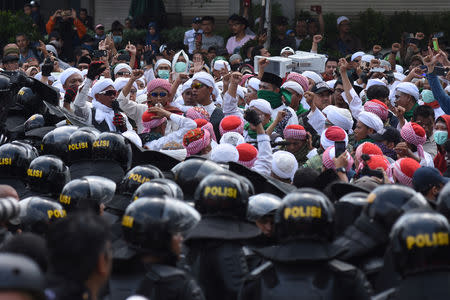 People protest outside the Elections Supervisory Agency (Bawaslu) office in Jakarta, Indonesia May 22, 2019 in this photo taken by Antara Foto. Antara Foto/Indrianto Eko Suwarso/ via REUTERS