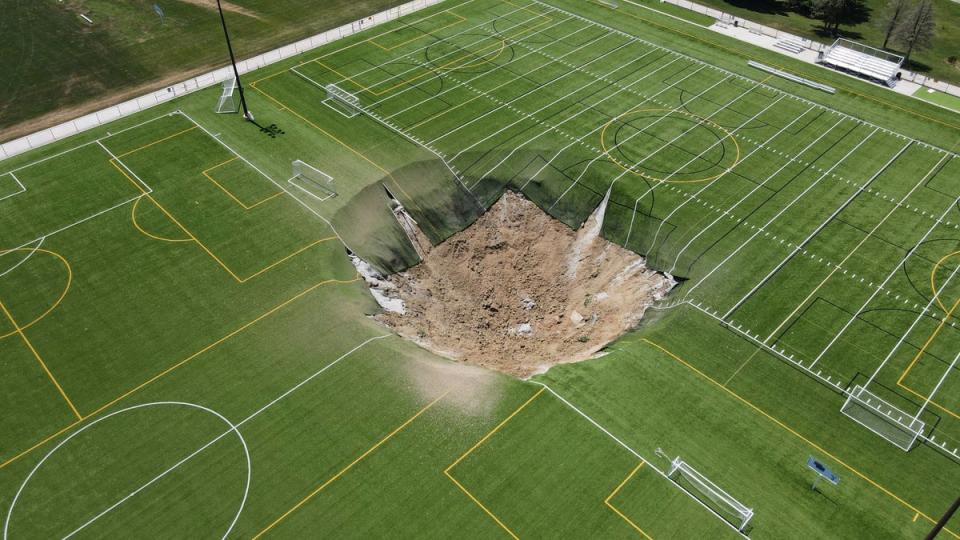 <p>A drone view shows a sinkhole that formed on a turf soccer field at Gordon Moore Park in Alton, Illinois</p> (REUTERS)