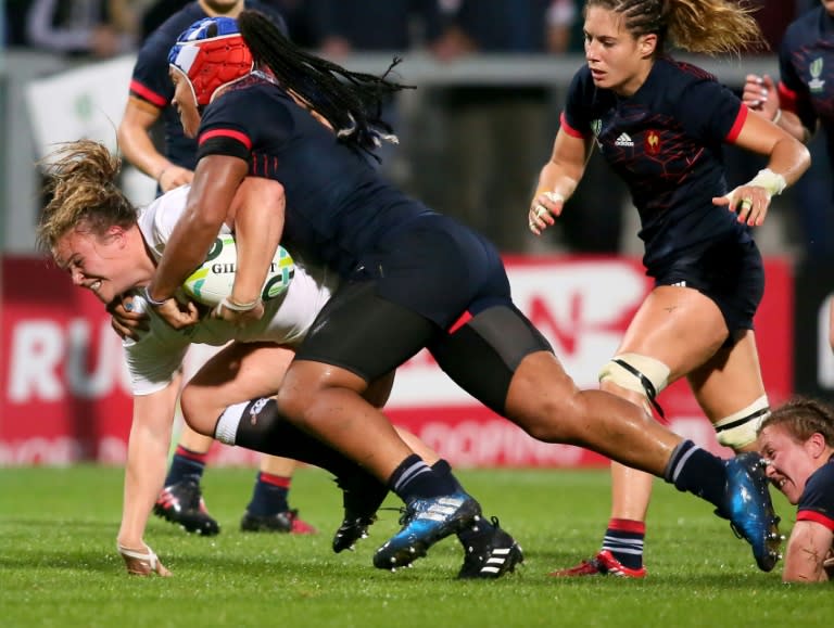 England's Sarah Bern (L) is tackled by France's Safi N'Diaye during the Women's Rugby World Cup 2017 semi-final match on August 22, 2017