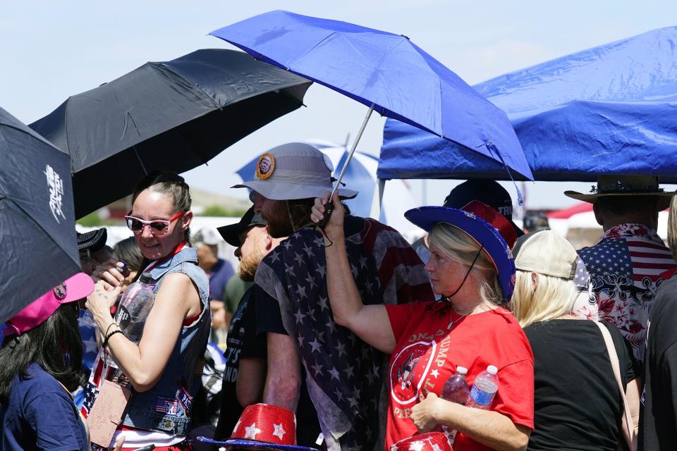 Supporters of former President Donald Trump wait in line hours before the former president is set to speak at a rally Friday, July 22, 2022, in Prescott, Ariz. (AP Photo/Ross D. Franklin)