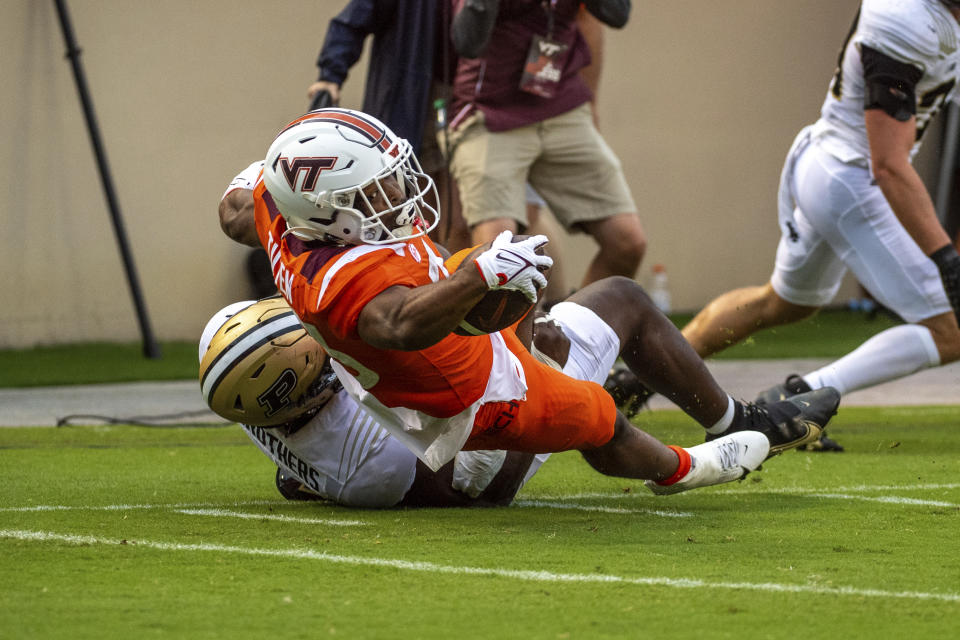 Virginia Tech's Bhayshul Tuten (33) runs in for a touchdown against Purdue during an NCAA college football Saturday, Sept. 9 2023, in Blacksburg, Va. (AP Photo/Robert Simmons)