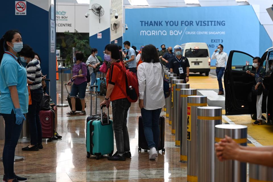 Passengers arrive at the departure area at Marina Bay Cruise Centre in Singapore. 