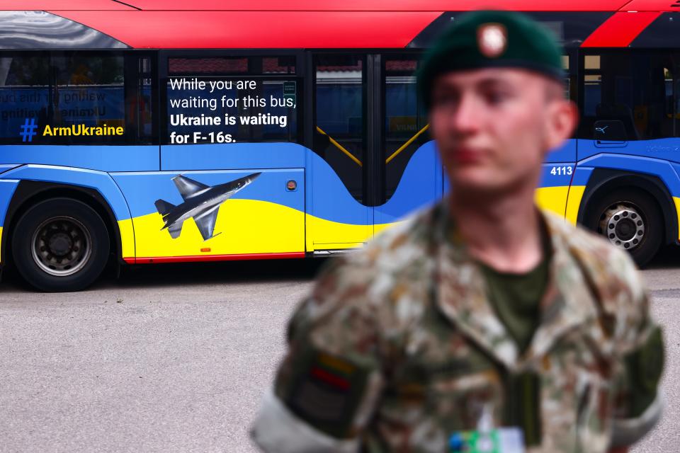 Arm Ukraine' slogan of campaign for supporting Ukraine with F-16s fighter jets is seen on a bus during NATO Summit in Vilnius, Lithuania on July 11, 2023.