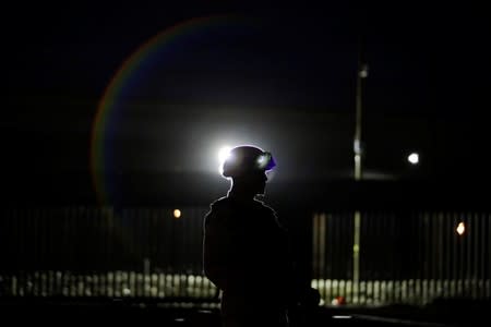 The silhouette of a member of the Mexican National Guard is pictured near the border between Mexico and U.S., as seen from Ciudad Juarez