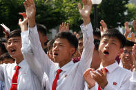 <p>People react as they watch the news that North Korean leader Kim Jong Un signed the order to carry out the test-fire of intercontinental ballistic rocket near the Pyongyang railway station in Pyongyang, North Korea, Tuesday, July 4, 2017. (Photo: Jon Chol Jin/AP) </p>