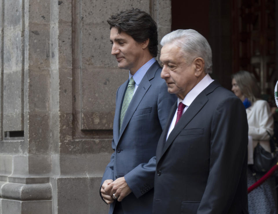 Canadian Prime Minister Justin Trudeau, left, walks with Mexican President Andres Manuel Lopez Obrador as he is greeted on his arrival at the National Palace in Mexico City, Mexico, Wednesday Jan. 11, 2023. (Adrian Wyld/The Canadian Press via AP)
