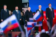 FILE - Russian President Vladimir Putin, center, speaks as Leonid Pasechnik, leader of self-proclaimed Luhansk People's Republic, left, Denis Pushilin, leader of self-proclaimed of the Donetsk People's Republic, second left, Moscow-appointed head of Kherson Region Vladimir Saldo, second right, and Moscow-appointed head of Zaporizhzhia region Yevgeny Balitsky, right, stand near him during celebrations marking the incorporation of regions of Ukraine to join Russia in Red Square in Moscow, Russia, Friday, Sept. 30, 2022. The signing of the treaties making the four regions part of Russia follows the completion of the Kremlin-orchestrated "referendums." (Sergei Karpukhin, Sputnik, Kremlin Pool Photo via AP, File)