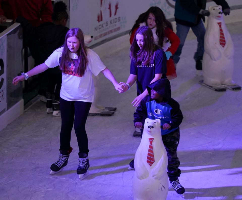 Ice skaters zip around the rink in Government Plaza Wednesday, Dec. 22, 2021. [Staff Photo/Gary Cosby Jr.]