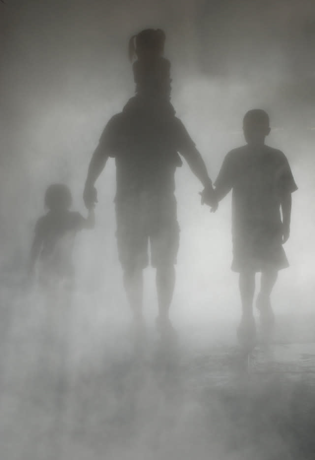 Father and children in shadows.