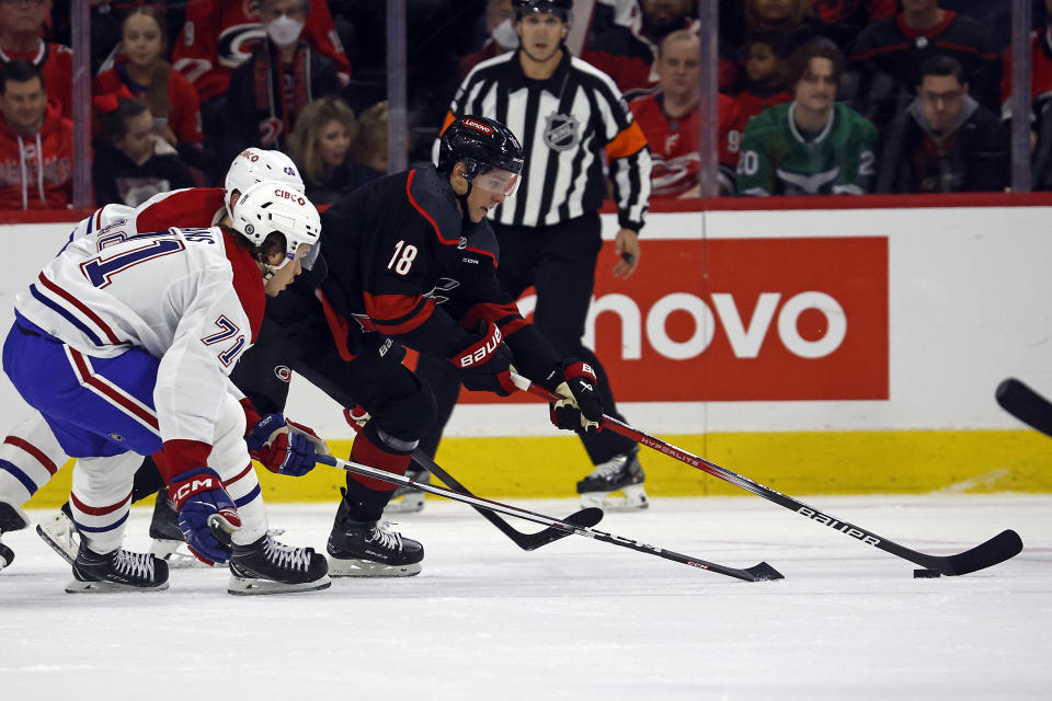 Carolina Hurricanes' Jack Drury (18) controls the puck in front of Montreal Canadiens' Joel Armia (40) and Jake Evans (71) during the first period of an NHL hockey game in Raleigh, N.C., Thursday, March 7, 2024. (AP Photo/Karl B DeBlaker)