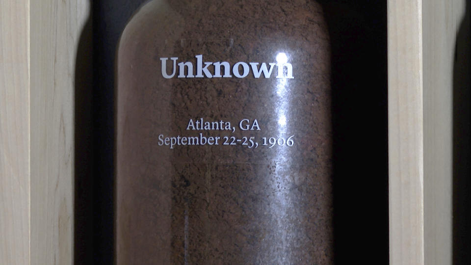 A jar of soil sits on display at the Auburn Avenue Research Library in Atlanta on June 10, 2022. The Stories from the Soil exhibit honors lynching victims with collected soil from those sites where incidents occurred. The jar represents unknown victims who were killed during the Atlanta Race Massacre. (AP Photo/Sharon Johnson)