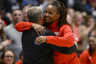 Dayton head coach Tamika Williams-Jeter embraces her former coach, UConn head coach Geno Auriemma at the end of an NCAA college basketball game, Wednesday, Nov. 8, 2023, in Hartford, Conn. (AP Photo/Jessica Hill)