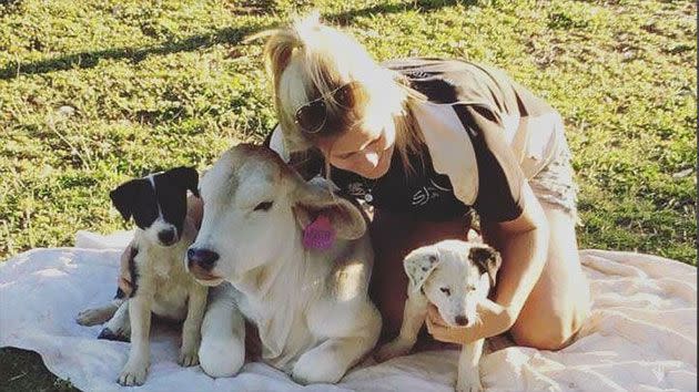 From a young age, Beryl would cuddle with the dogs and drink milk from the same bowl as them. Photo: Facebook