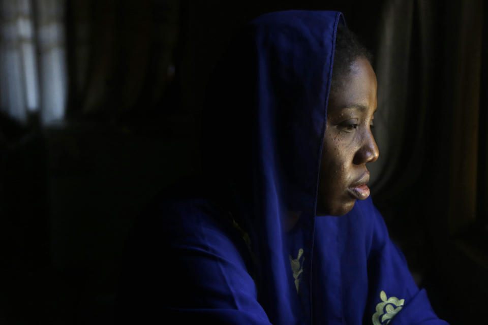 FILE - Amina Ahmed, the wife of Muhammad Mubarak Bala, an atheist who has been detained since April 2020, is photograph in her home in Abuja, Nigeria, Sunday, Nov. 21, 2021. She went to see him most recently with their 3-year-old son who was only six weeks old when Bala was taken into custody. He is in good spirits, Ahmed said of her husband. But it has been difficult for her, beginning when she was healing from childbirth while her husband remained behind bars. (AP Photo/Sunday Alamba, File)