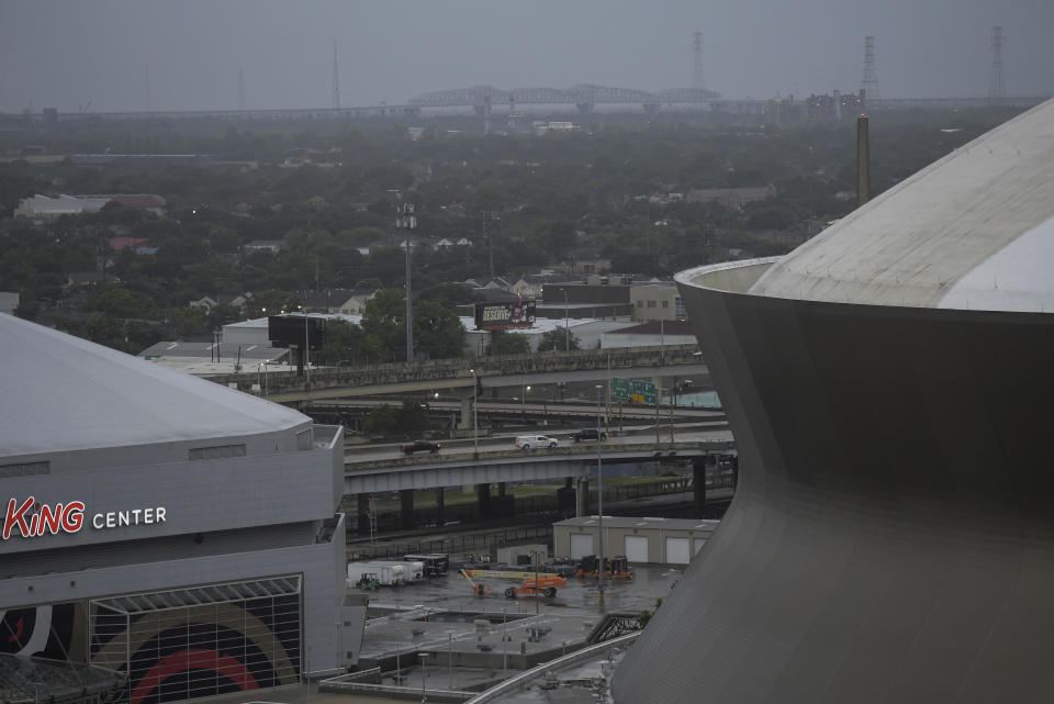 Through the morning rain the Huey P Long Bridge can be seen between the Caesars Superdome and the Smoothie King Center as Hurricane Ida approaches the Louisiana coast in New Orleans, La. Sunday, Aug. 29, 2021. (Max Becherer/The Advocate via AP)