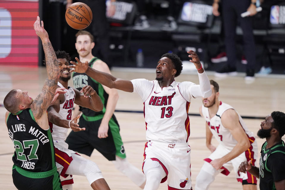 Miami Heat's Bam Adebayo (13) and Boston Celtics' Daniel Theis (27) battle for the ball during the second half of an NBA conference final playoff basketball game Friday, Sept. 25, 2020, in Lake Buena Vista, Fla. (AP Photo/Mark J. Terrill)