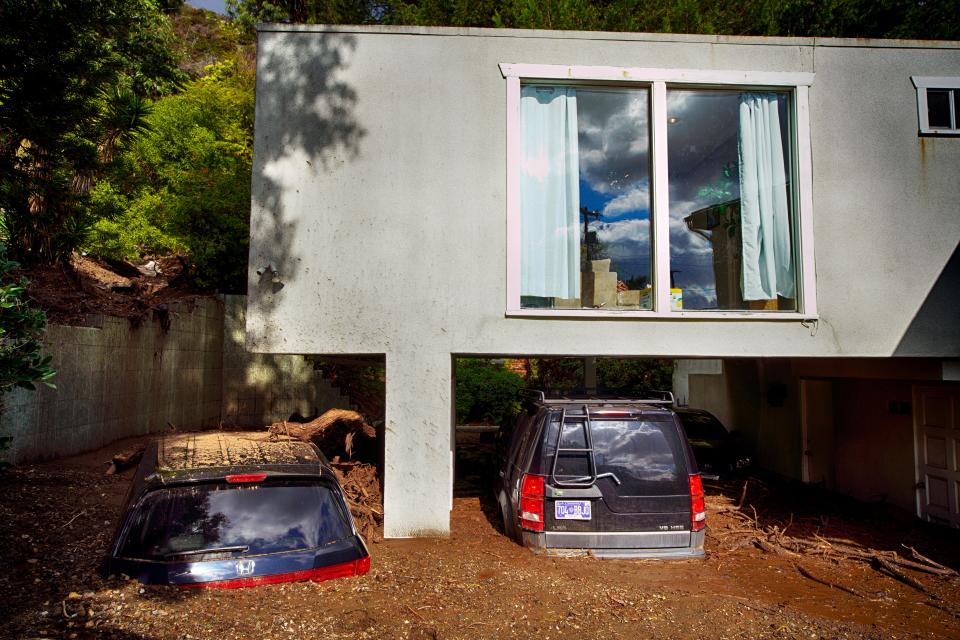 Cars are seen buried by mud in the garage of a home in Los Angeles on Wednesday, Feb. 7, 2024 (Copyright 2024 The Associated Press. All rights reserved.)