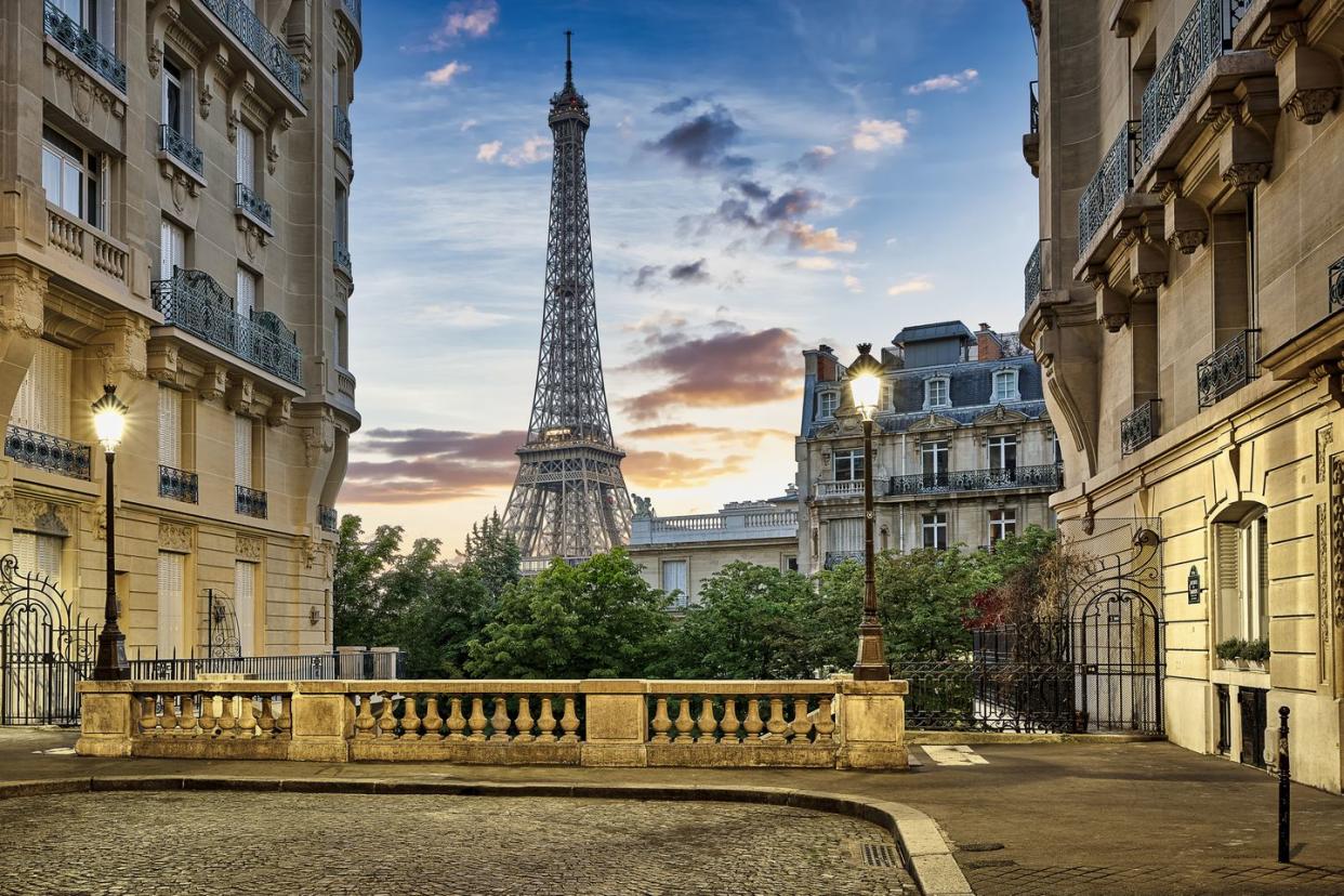 eiffel tower with haussmann apartment buildings in foreground, paris, france