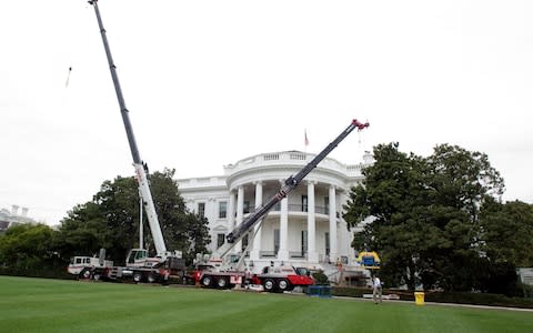 Construction cranes on the South Lawn of the White House looking towards the South Portico in Washington, DC is undergoing renovations - Credit: Alamy 
