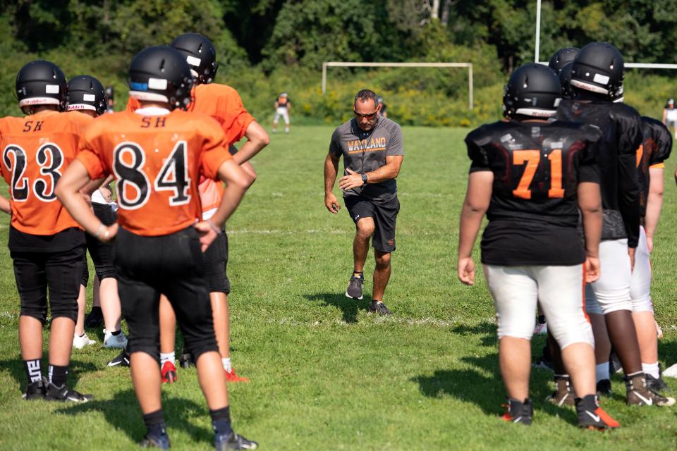 Wayland High head coach Scott Parseghian runs the team through drills during football practice at the high school, Aug. 26, 2021.