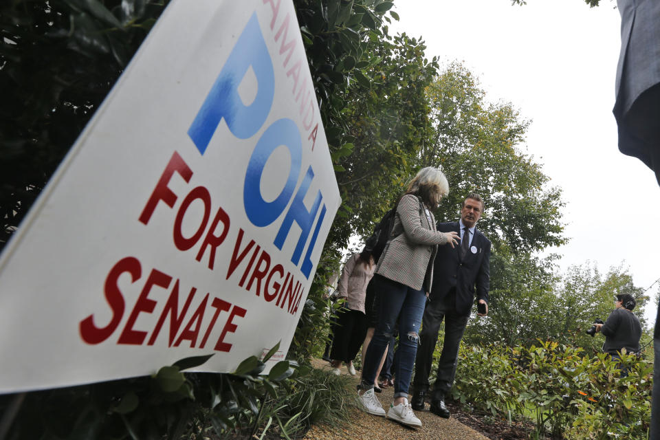 Actor Alec Baldwin, right, walks with a supporter of Amanda Pohl, candidate for Virginia Senate District 11 in her neighborhood in Midlothian, Va., Tuesday, Oct. 22, 2019. Baldwin campaigned for several candidates around the state. (AP Photo/Steve Helber)