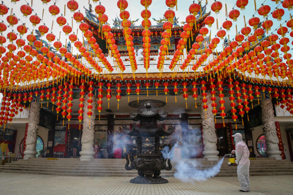 A temple worker sprays disinfectant at the Thean Hou Temple in Kuala Lumpur, January 19, 2022. — Picture by Yusof Mat Isa