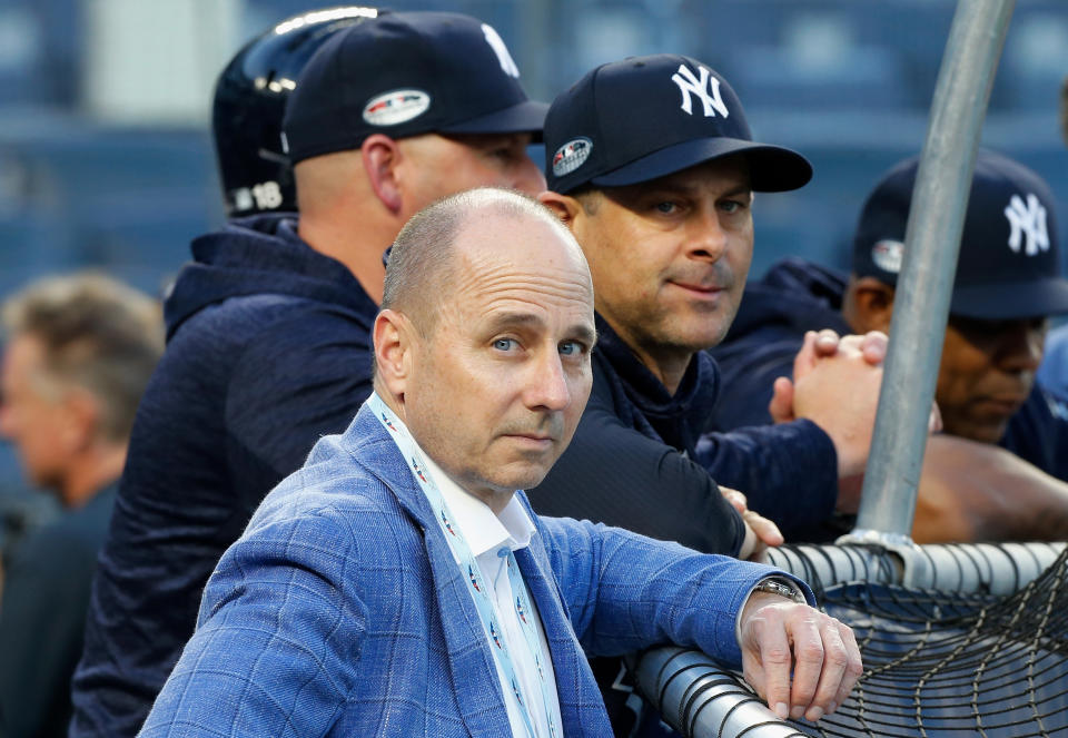 NEW YORK, NY - OCTOBER 09:  (NEW YORK DAILIES OUT)   General Manager Brian Cashman and Manager Aaron Boone #17 of the New York Yankees during batting practice before Game Four of the American League Division Series against the Boston Red Sox at Yankee Stadium on October 9, 2018 in the Bronx borough of New York City. The Red Sox defeated the Yankees  4-3.  (Photo by Jim McIsaac/Getty Images)