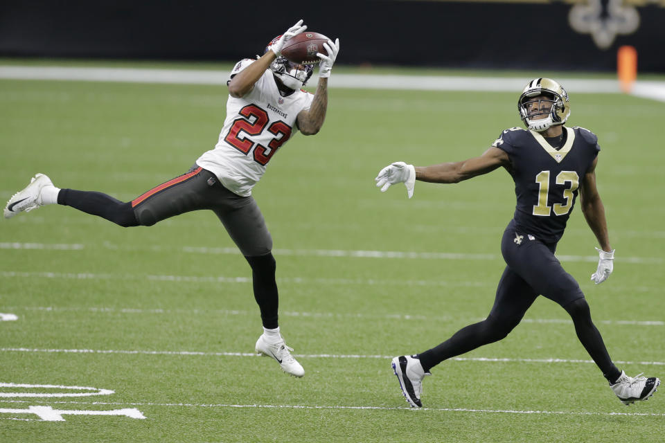 Tampa Bay Buccaneers cornerback Sean Murphy-Bunting (23) intercepts a pass intended for New Orleans Saints wide receiver Michael Thomas (13) during the first half of an NFL divisional round playoff football game, Sunday, Jan. 17, 2021, in New Orleans. (AP Photo/Brett Duke)