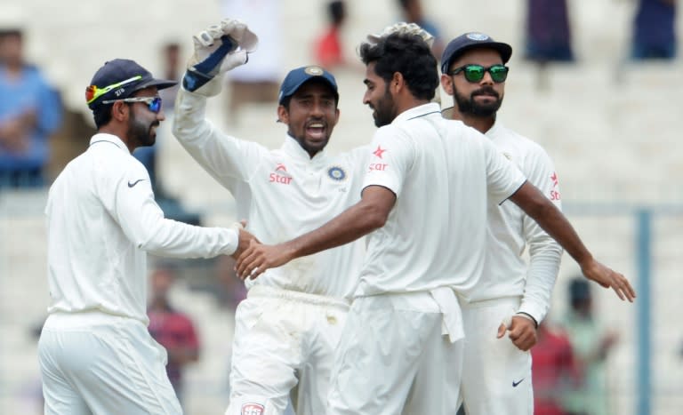 India's Bhuvneshwar Kumar (2nd right) celebrates with teammates after dismissing New Zealand's Martin Guptill (not in picture) during the second day of the second Test match at the Eden Gardens in Kolkata, on October 1, 2016